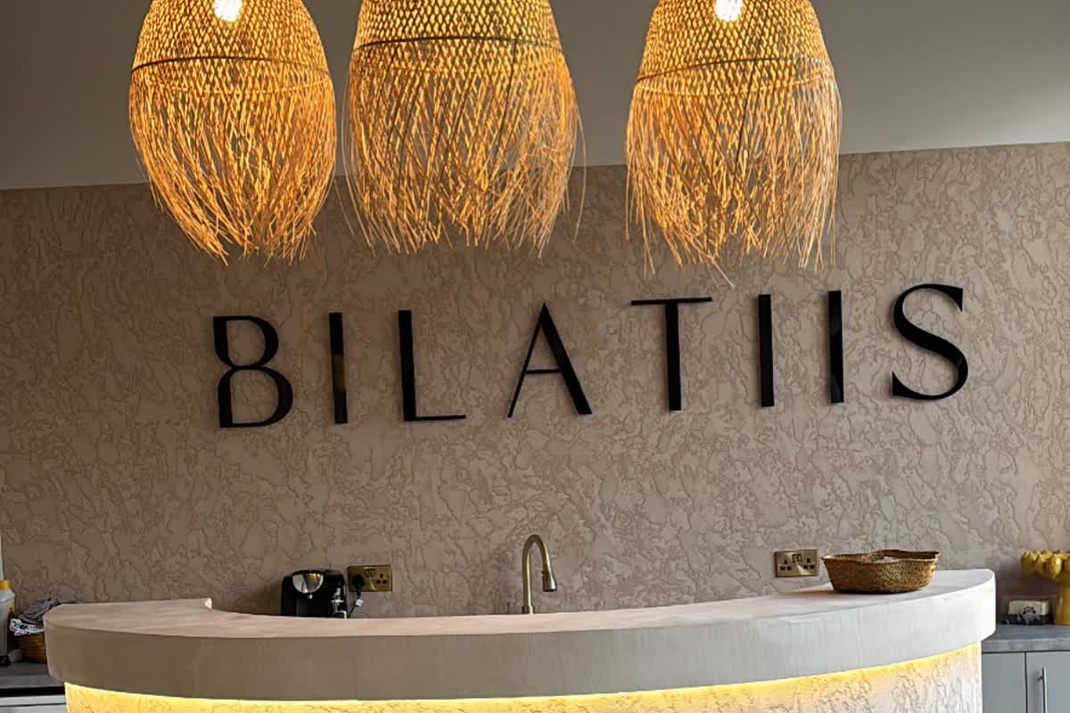 Bilatiis Studio reception desk: Bespoke textured finish on a curved reception desk for a Pilates studio. Neutral tones, flawless edges, the first thing every client sees.