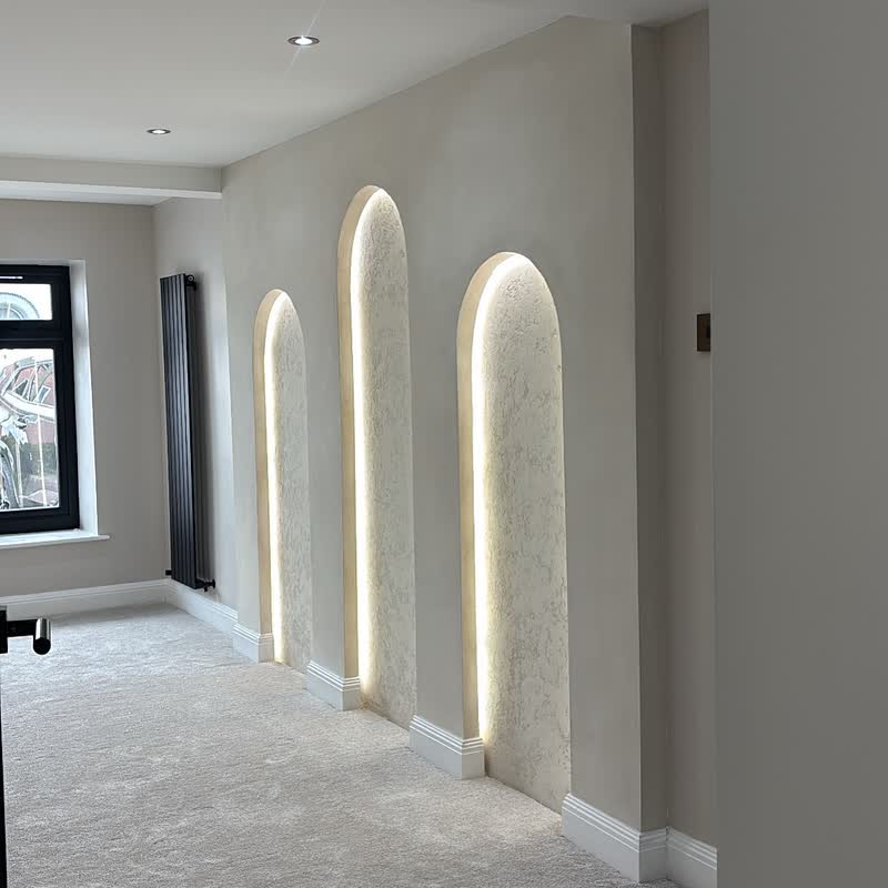 Curved limewashed arches: Paired with textured venetian plaster for depth and movement through the space.